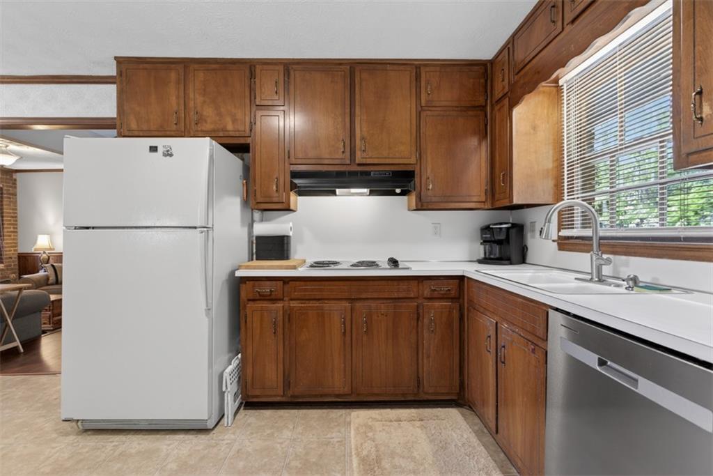 1177 Charlie Lane Southwest Lilburn, GA 30047 - Photo 21 of 49 a kitchen with a refrigerator sink and cabinets