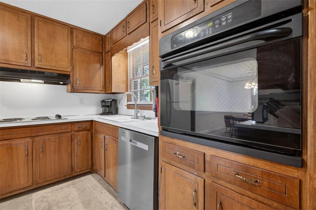 1177 Charlie Lane Southwest Lilburn, GA 30047 - Photo 22 of 49 a kitchen with stainless steel appliances granite countertop a sink and cabinets