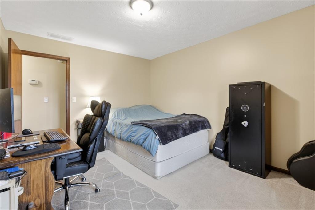 1177 Charlie Lane Southwest Lilburn, GA 30047 - Photo 29 of 49 a bedroom with a bed and a desk