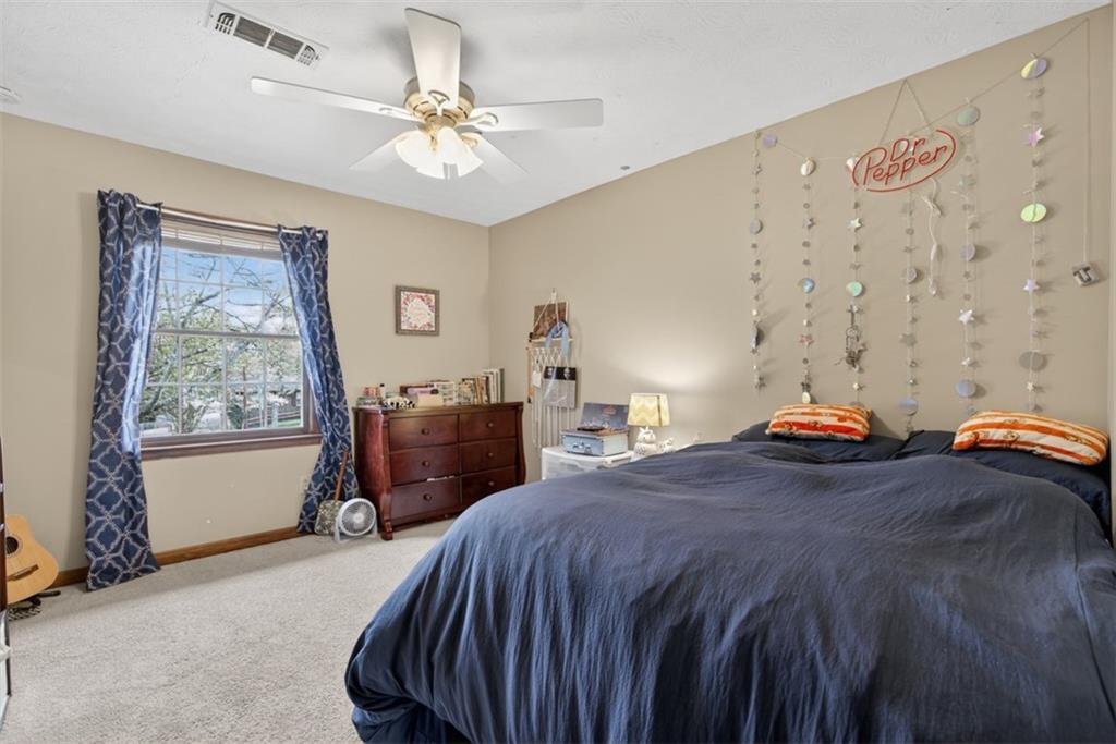 1177 Charlie Lane Southwest Lilburn, GA 30047 - Photo 32 of 49 a bed room with a bed and a chair