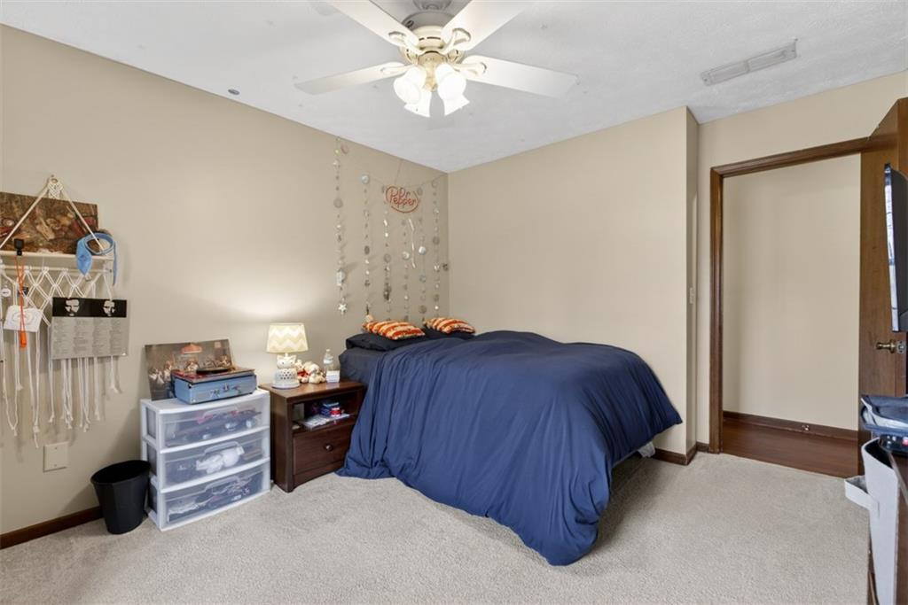 1177 Charlie Lane Southwest Lilburn, GA 30047 - Photo 33 of 49 a bed room with a bed and a ceiling fan
