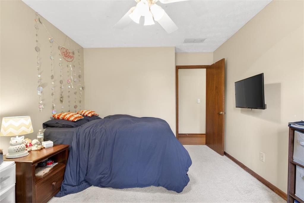 1177 Charlie Lane Southwest Lilburn, GA 30047 - Photo 34 of 49 a bedroom with a bed and flat screen tv