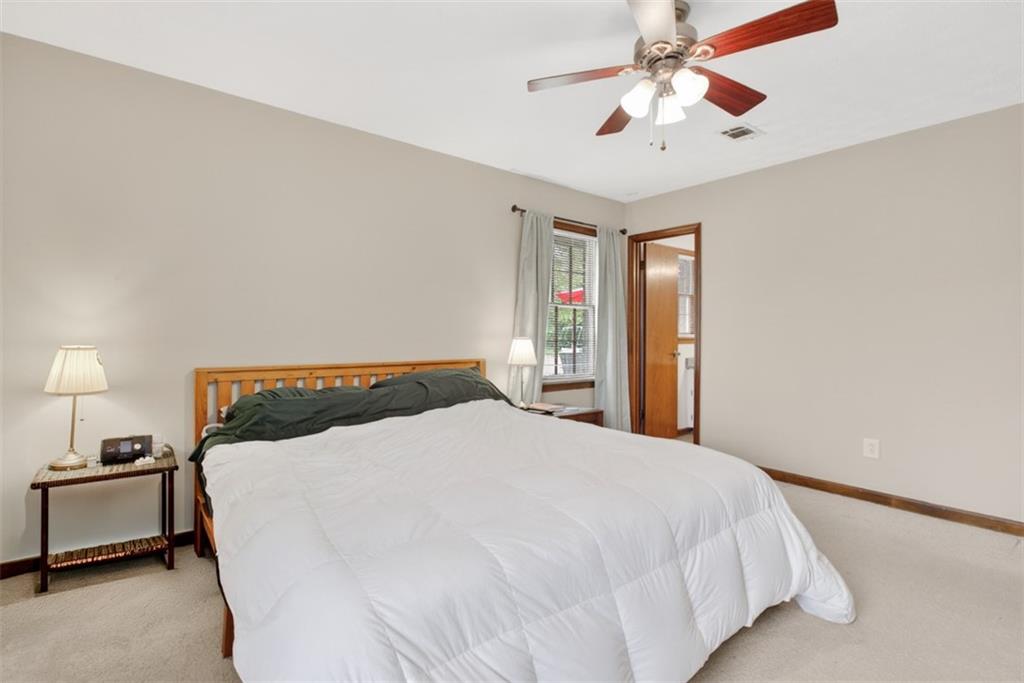 1177 Charlie Lane Southwest Lilburn, GA 30047 - Photo 36 of 49 a bedroom with a bed and a chandelier