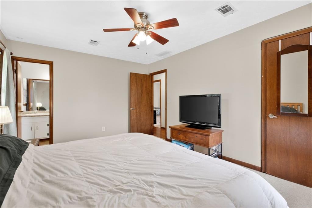 1177 Charlie Lane Southwest Lilburn, GA 30047 - Photo 37 of 49 a bedroom with a bed and a flat screen tv