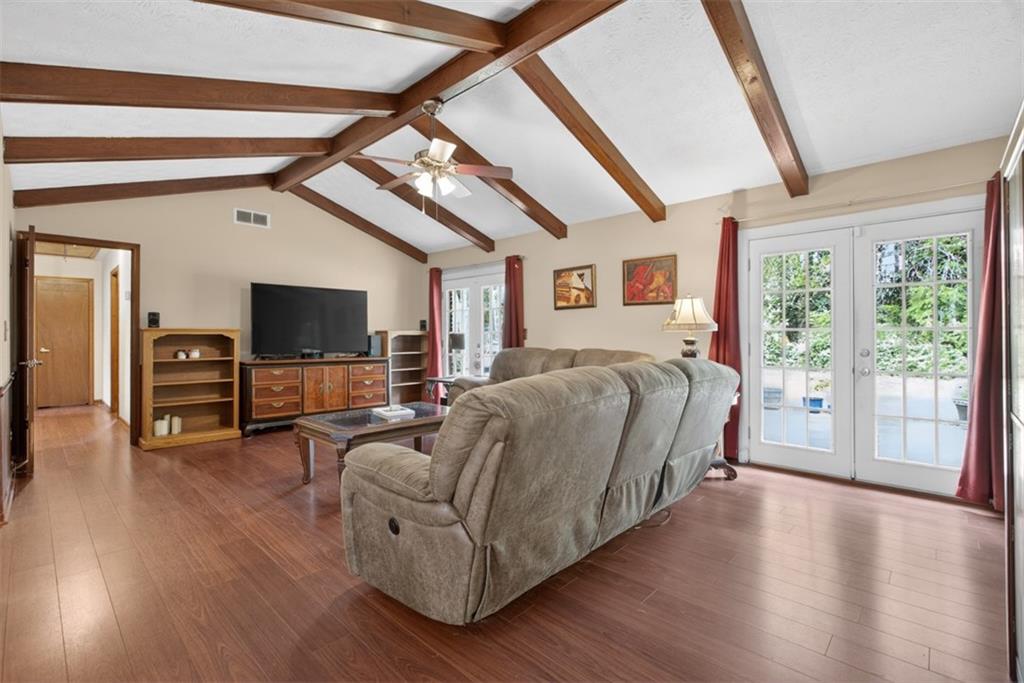 1177 Charlie Lane Southwest Lilburn, GA 30047 - Photo 10 of 49 a spacious bedroom with a bed and wooden floor