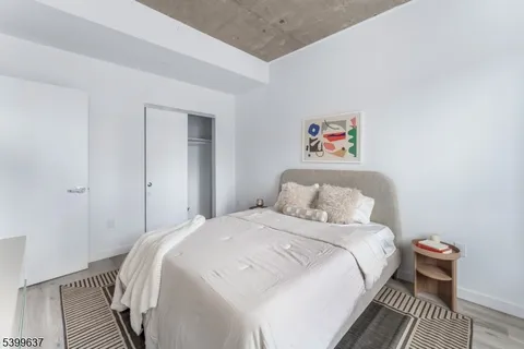 a bedroom with a bed and a painting on the wall