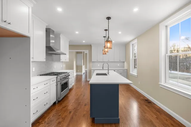 a kitchen with stainless steel appliances granite countertop a sink stove and refrigerator