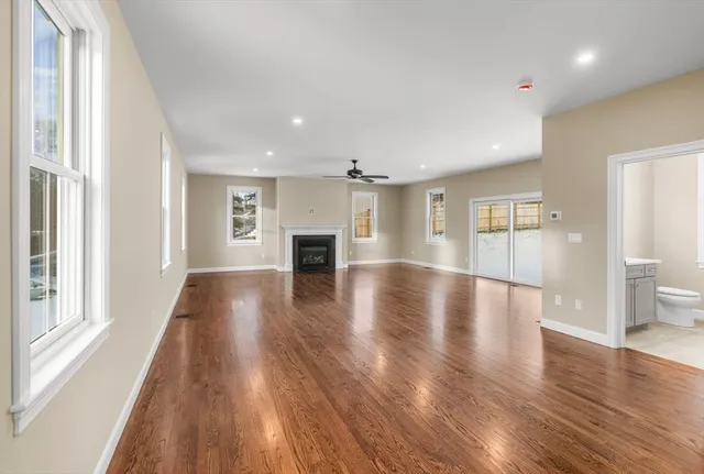 wooden floor in an empty room with a window