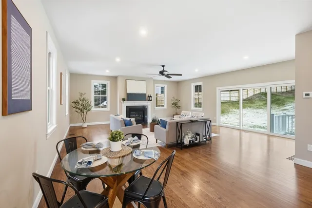 a living room with furniture a fireplace and a table