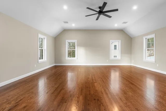 a view of a livingroom with a ceiling fan and window