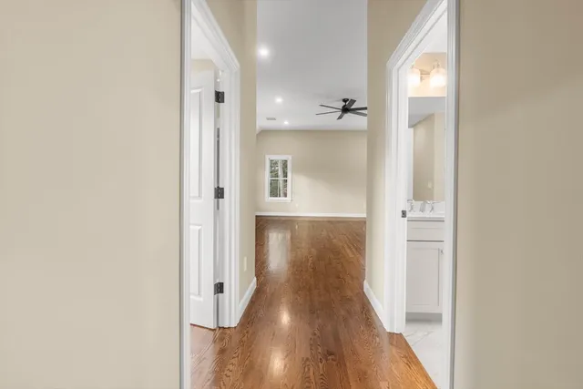 a view of a hallway with wooden floor