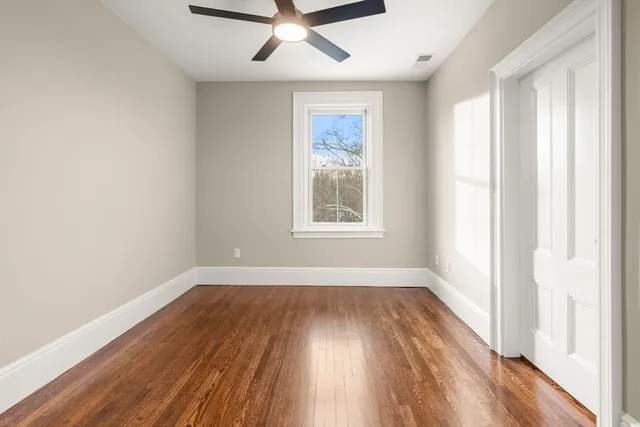 wooden floor in an empty room with a window