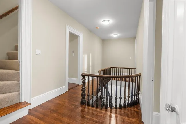 a view of hallway with wooden floor