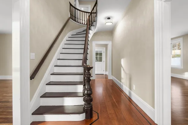 a view of entryway and hall with wooden floor