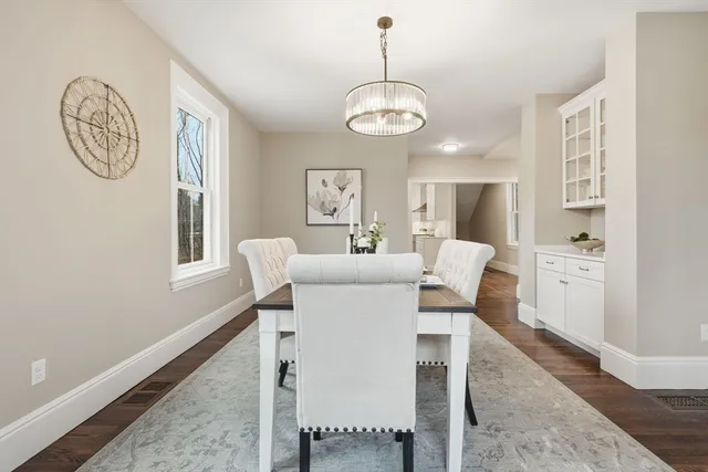 a view of a dining room with furniture and a chandelier