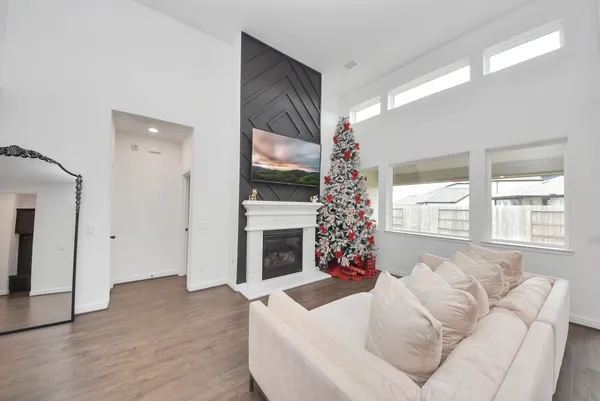 a living room with furniture a flat screen tv and a fireplace