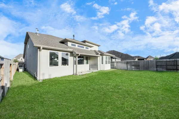 a view of house with backyard