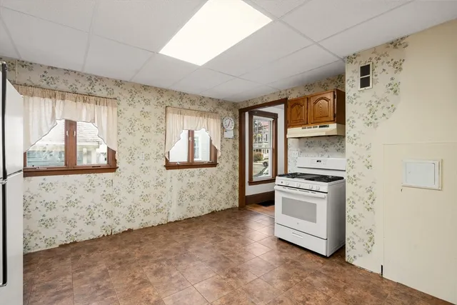 a view of kitchen with stainless steel appliances cabinets
