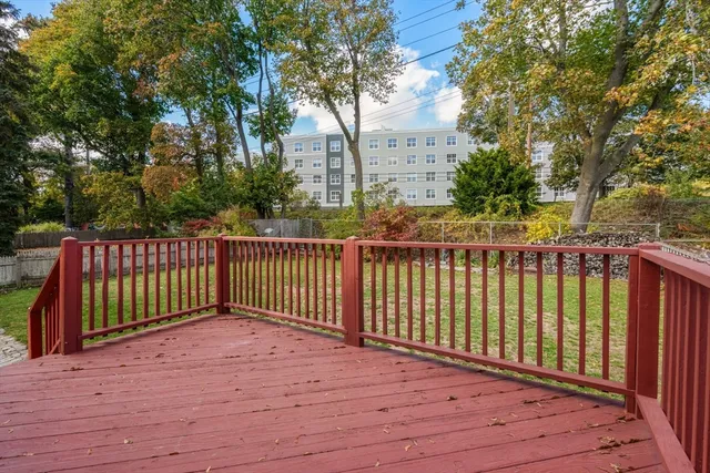 a view of balcony with wooden floor and fence
