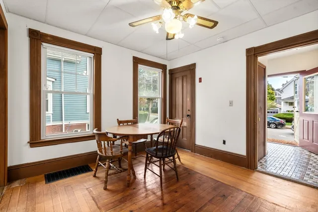 a view of a dining room with furniture window and wooden floor