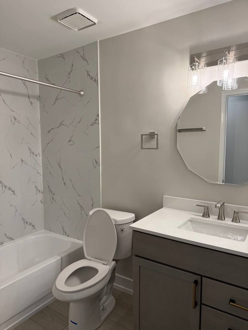 2403 Mallow Court, Unit Z1 Schaumburg, IL 60107 - Photo 15 of 17 a bathroom with a sink toilet and shower