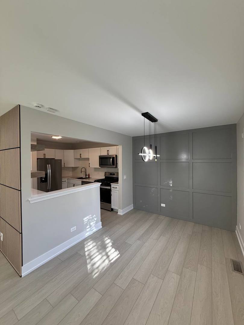 2403 Mallow Court, Unit Z1 Schaumburg, IL 60107 - Photo 2 of 17 a open kitchen with cabinets and wooden floor