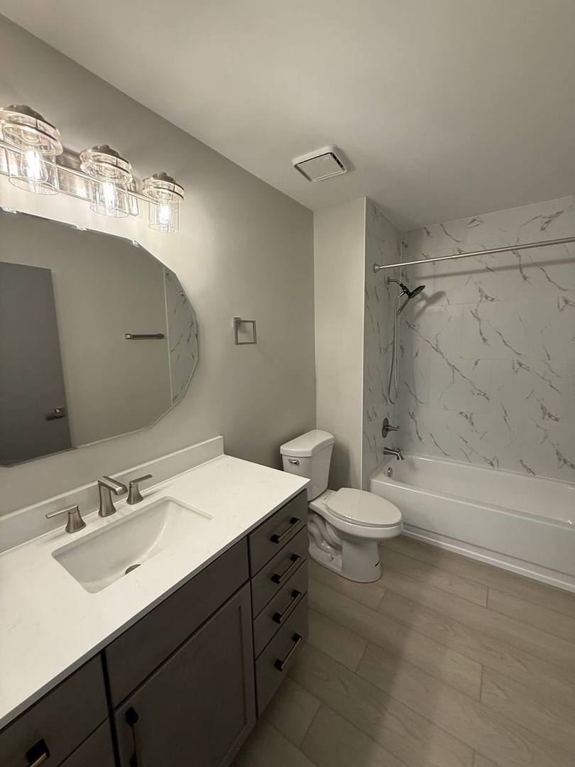 2403 Mallow Court, Unit Z1 Schaumburg, IL 60107 - Photo 10 of 17 a bathroom with a double vanity sink toilet and shower