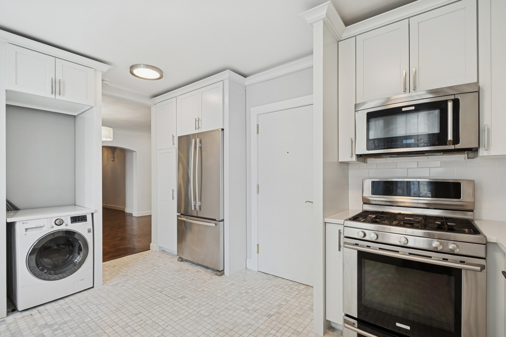 1640 East 50th Street, Unit 13B Chicago, IL 60615 - Photo 9 of 16 a kitchen with cabinets and steel stainless steel appliances