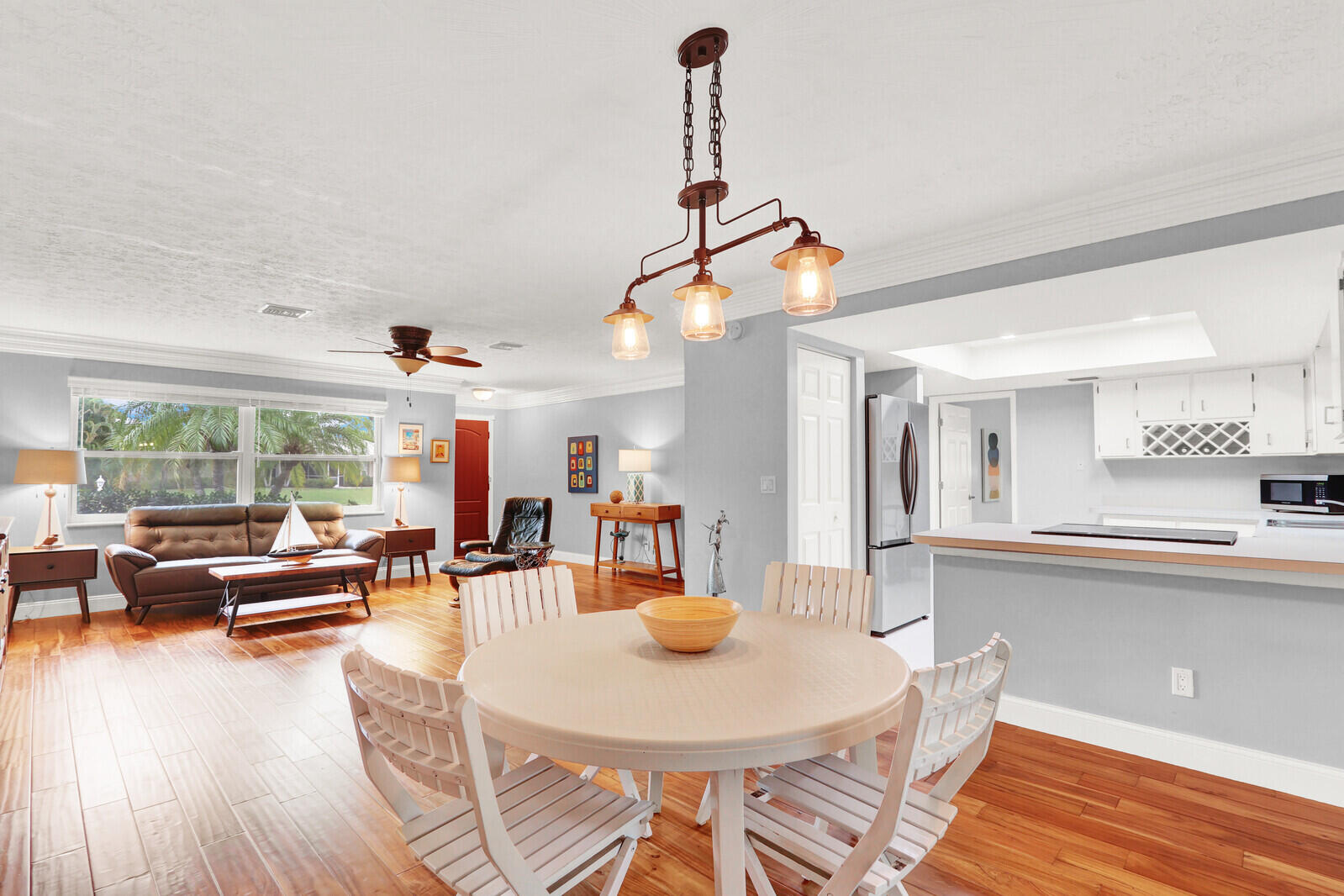 3035 Southeast Glasgow Drive Stuart, FL 34997 - Photo 11 of 52 a view of a dining room with furniture window and wooden floor