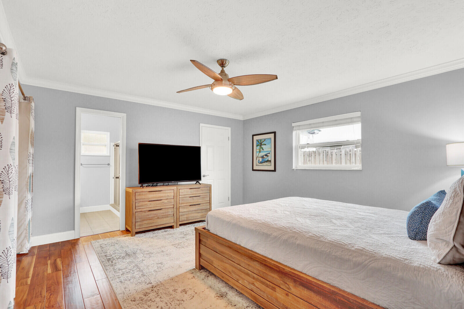 3035 Southeast Glasgow Drive Stuart, FL 34997 - Photo 20 of 52 a bedroom with a large bed and a flat screen tv