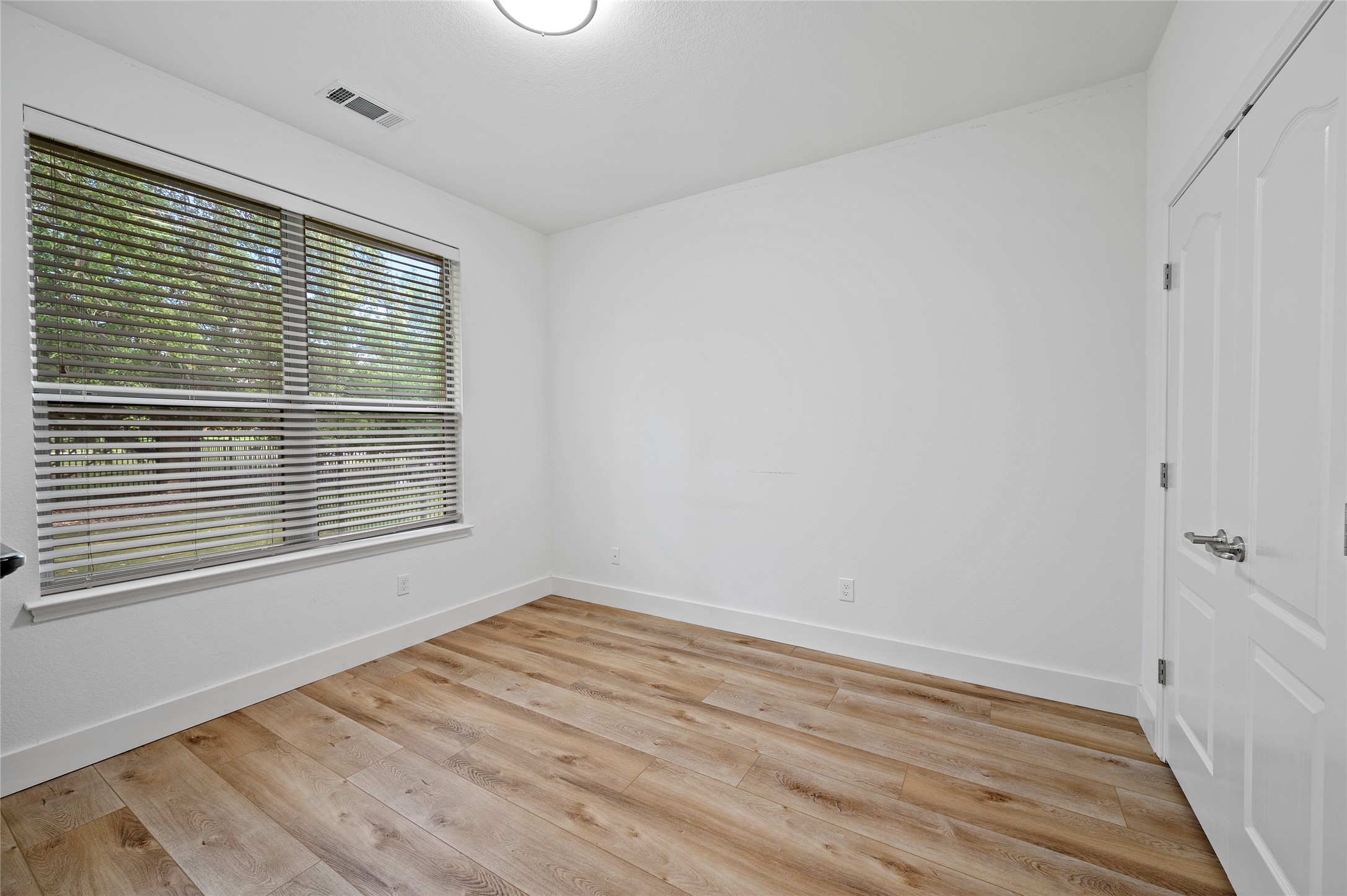 4512 Pyrenees Pass Bee Cave, TX 78738 - Photo 29 of 35 a view of an empty room with wooden floor and a window