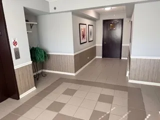 an entryway with wooden floor and livingroom view