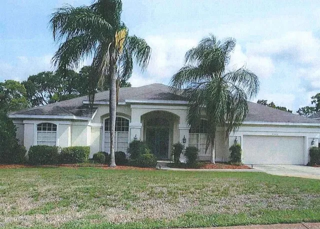 a view of a yard in front of a house with a fountain