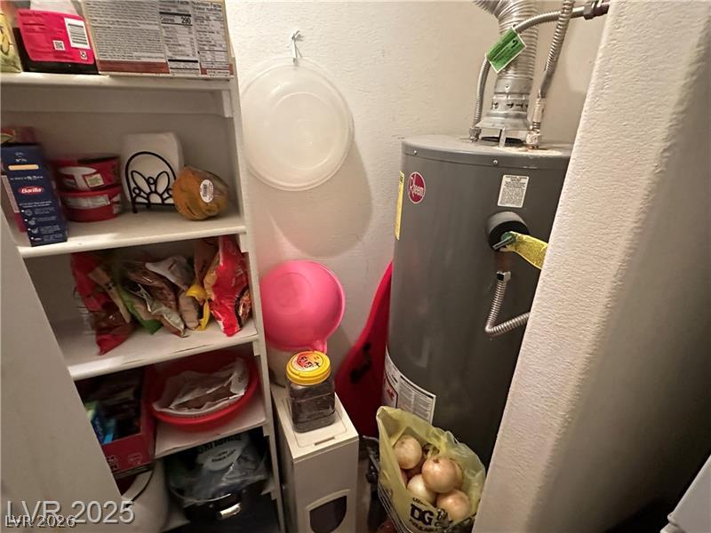 1830 North Pecos Road, Unit 230 Las Vegas, NV 89115 - Photo 9 of 16 Functional utility space with dedicated storage shelving and a water heater.