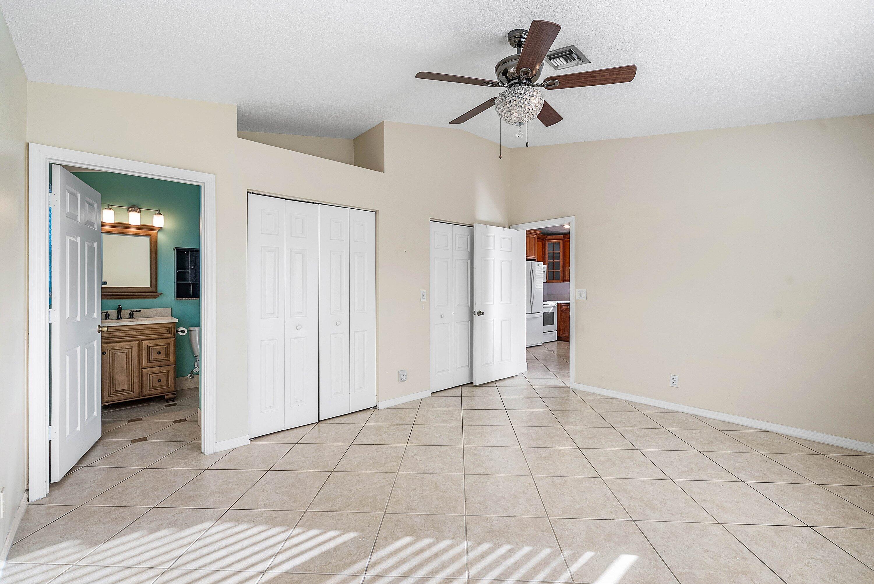 177 Heming Way Boynton Beach, FL 33426 - Photo 12 of 28 a view of a livingroom with a ceiling fan & entryway