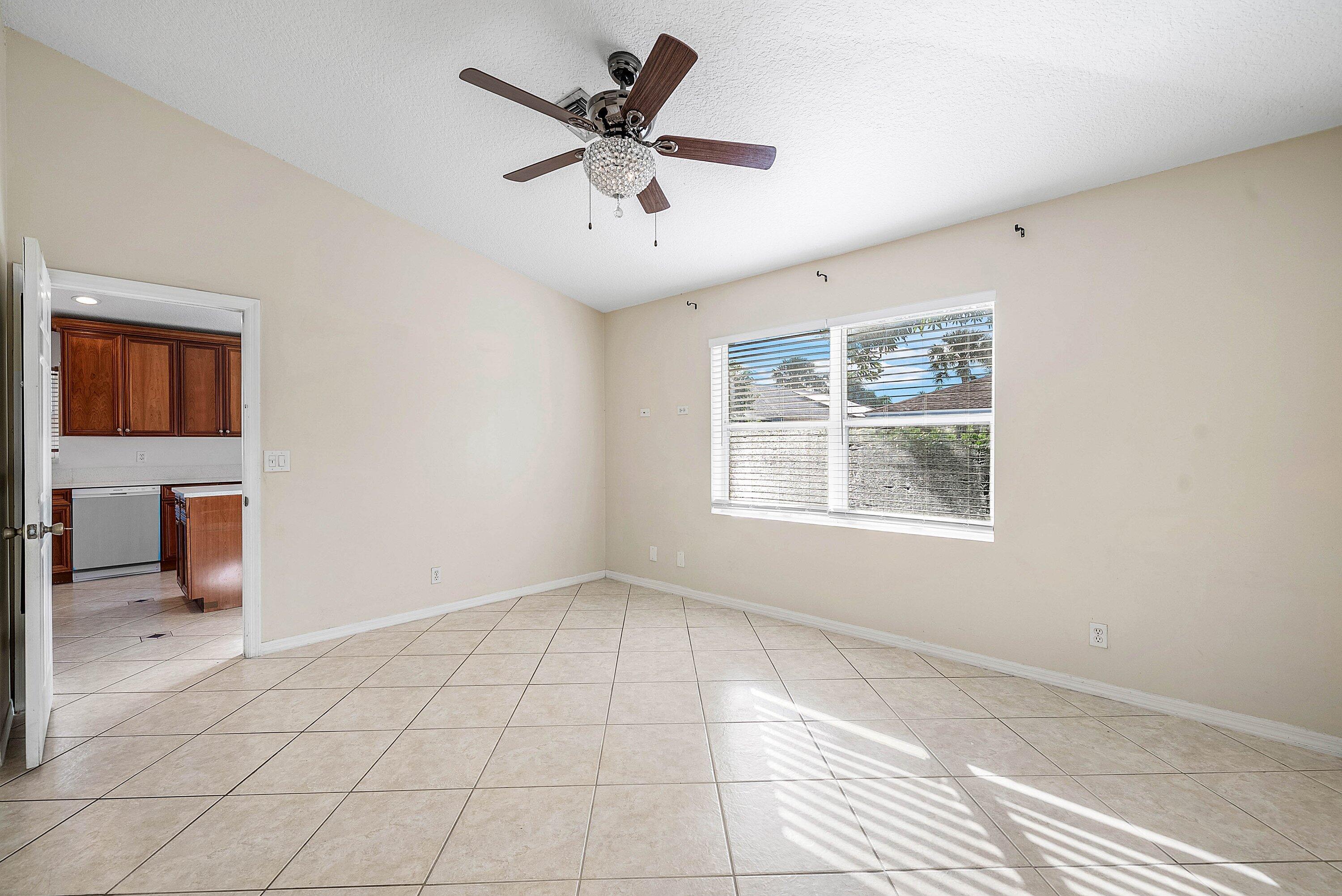 177 Heming Way Boynton Beach, FL 33426 - Photo 13 of 28 en empty room with windows and ceiling fan
