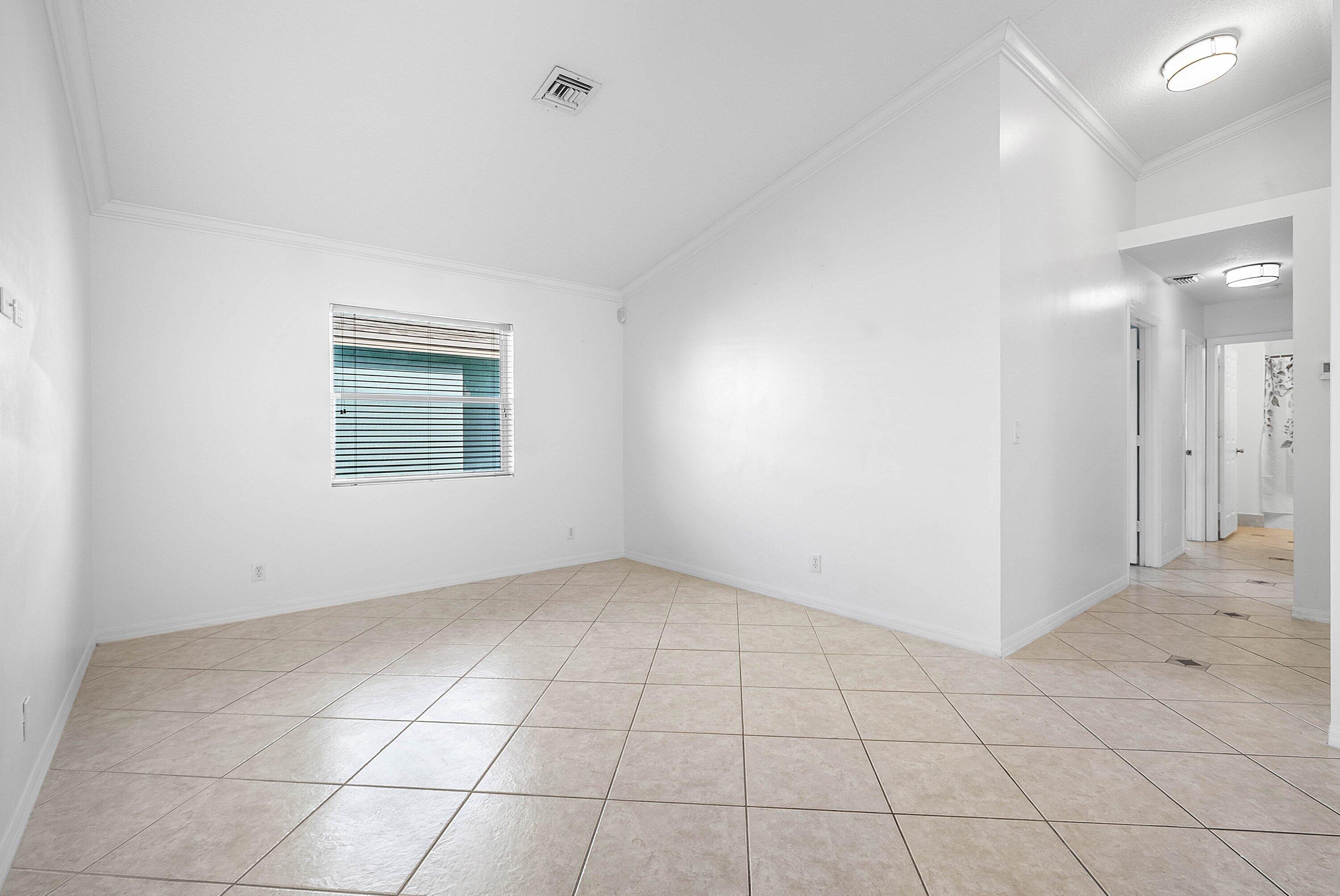 177 Heming Way Boynton Beach, FL 33426 - Photo 7 of 28 an empty room with white walls and windows