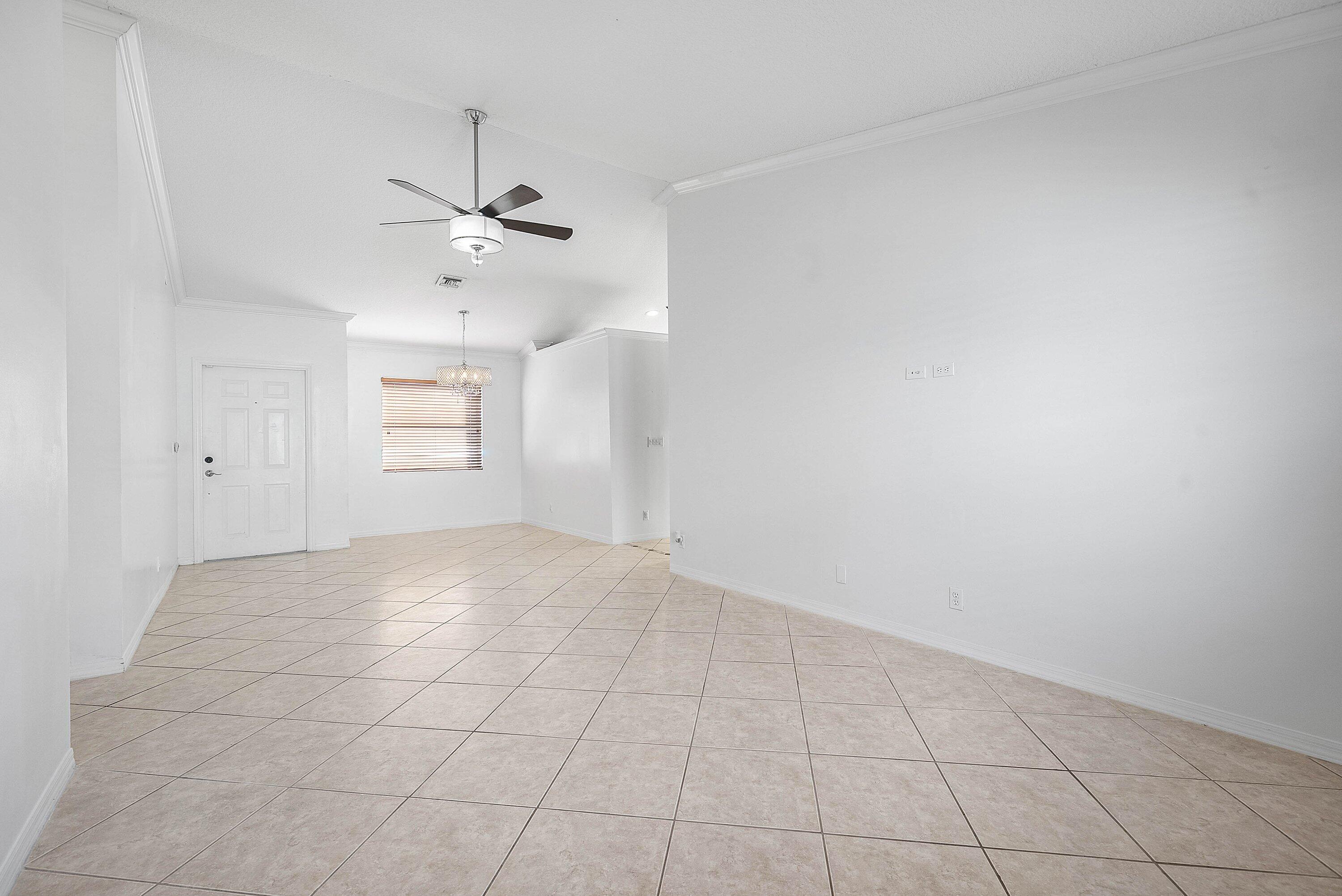177 Heming Way Boynton Beach, FL 33426 - Photo 8 of 28 wooden floor in an empty room with a window