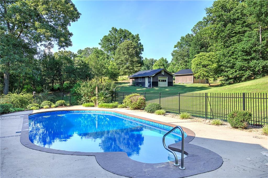 408 Mac Johnson Road Northwest Cartersville, GA 30121 - Photo 70 of 79 a swimming pool with outdoor seating and yard