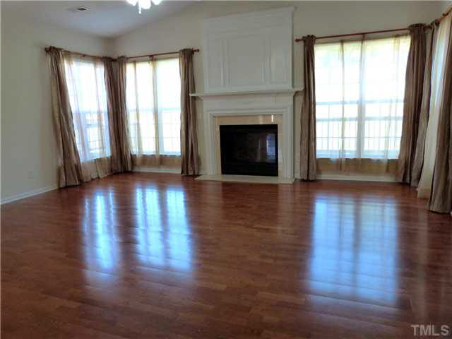 7500 Lagrange Drive Raleigh, NC 27613 - Photo 3 of 20 Very spacious family room (19.83x19.33) with a great view to the rolling hill private backyard view and a cozy gas fireplace. Den/Family/Great Room