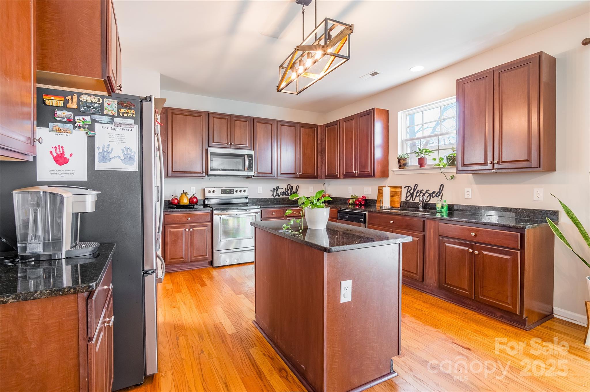 15127 Taylor Ridge Lane Charlotte, NC 28273 - Photo 12 of 42 a kitchen with stainless steel appliances granite countertop a stove top oven a sink and a refrigerator