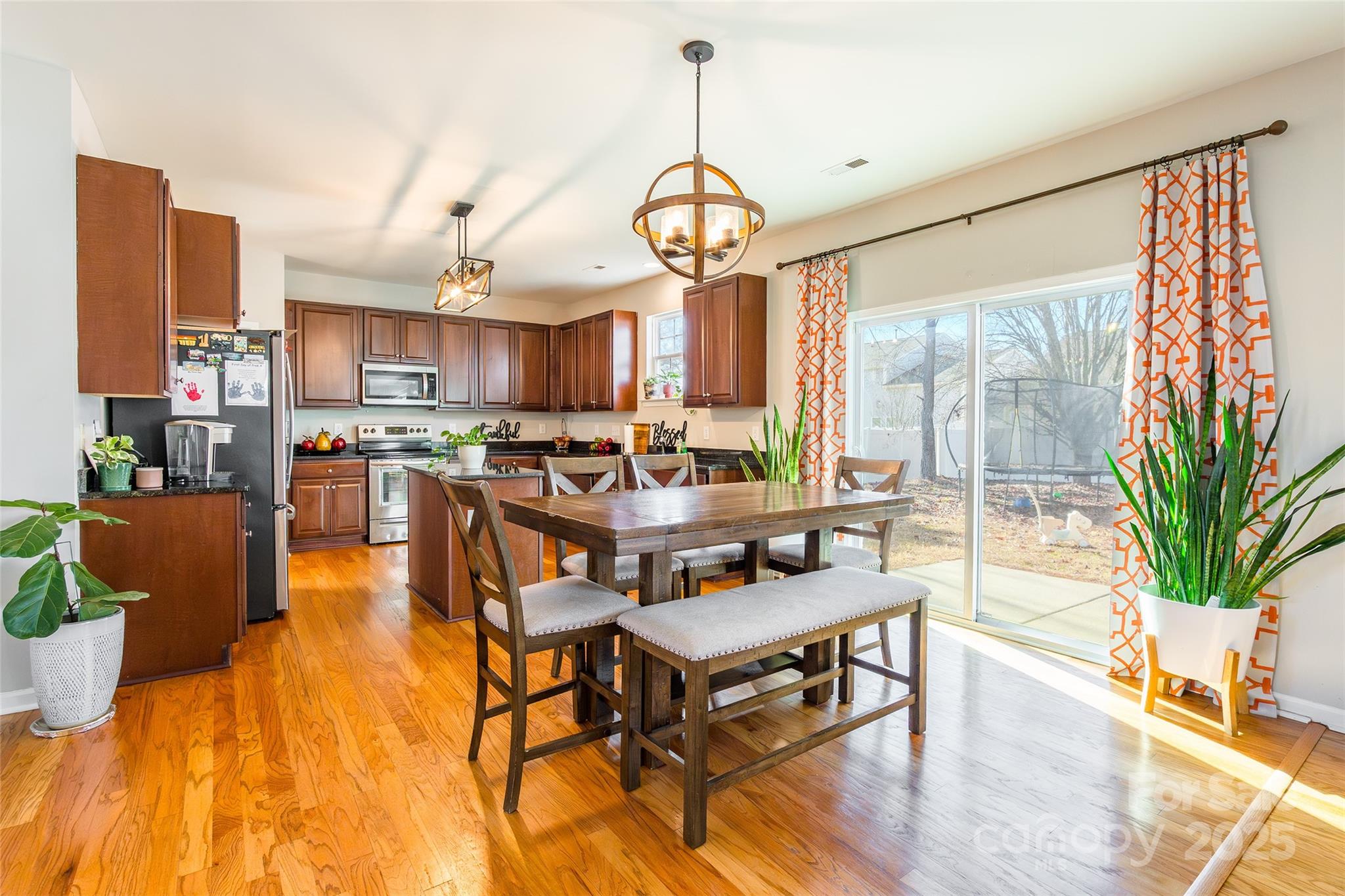 15127 Taylor Ridge Lane Charlotte, NC 28273 - Photo 10 of 42 a living room with kitchen island furniture and a chandelier