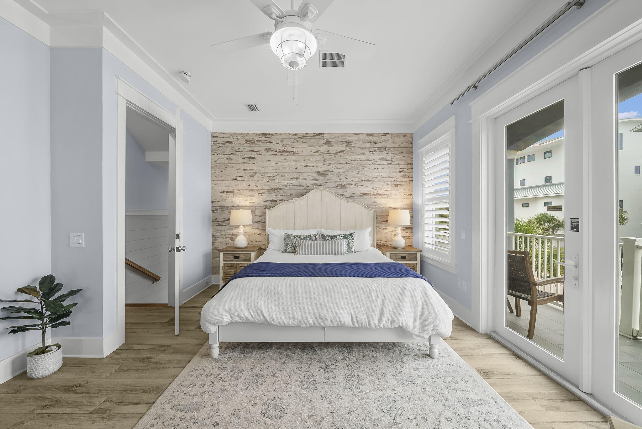 93 Emerald Cove Lane North Inlet Beach, FL 32461 - Photo 21 of 68 a spacious bedroom with a bed and a potted plant