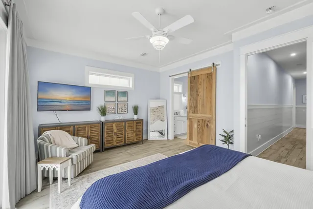 a bedroom with a bed and a chandelier