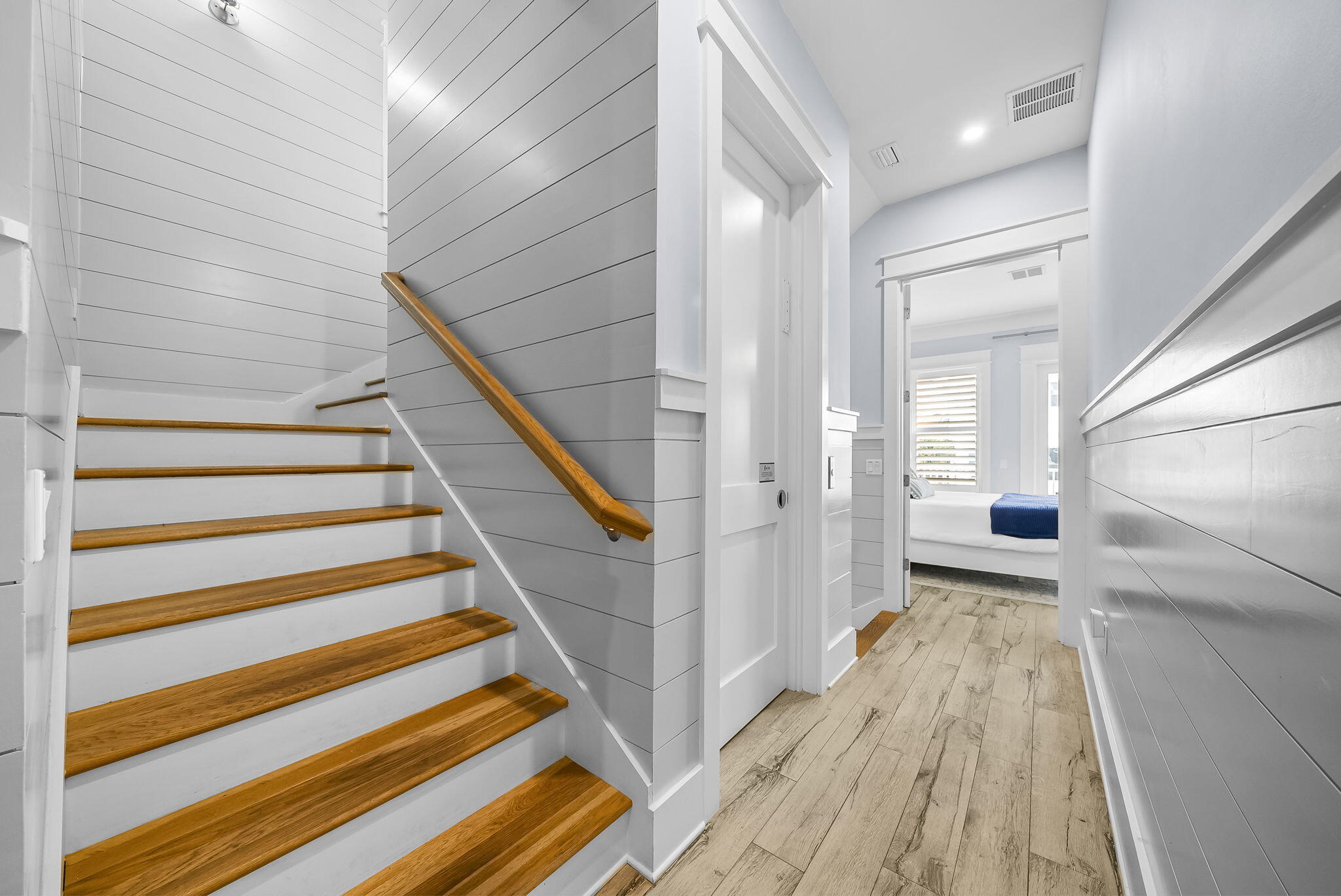 93 Emerald Cove Lane North Inlet Beach, FL 32461 - Photo 36 of 68 a view of a hallway with wooden floor and staircase