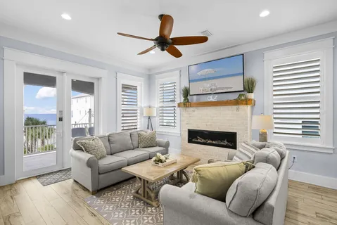 a view of a patio with a table and chairs in front of it