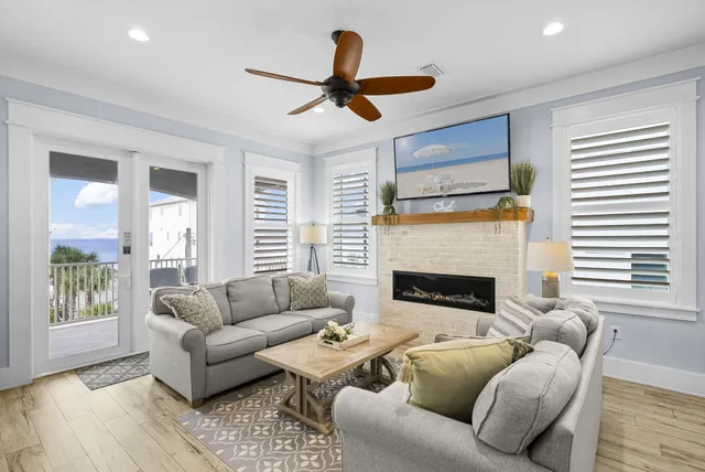 a view of a patio with a table and chairs in front of it