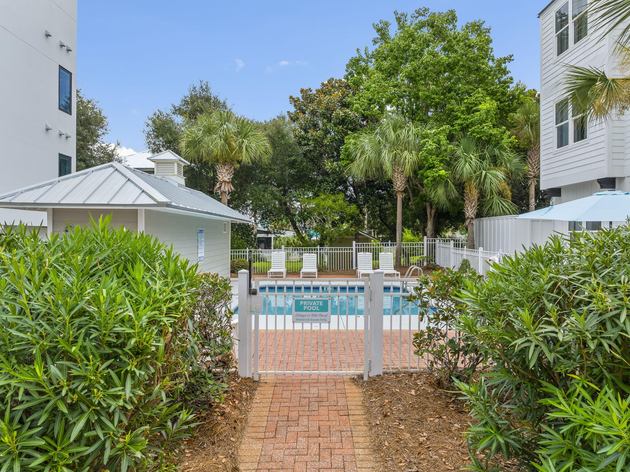93 Emerald Cove Lane North Inlet Beach, FL 32461 - Photo 55 of 68 a view of a house with brick walls and a garden