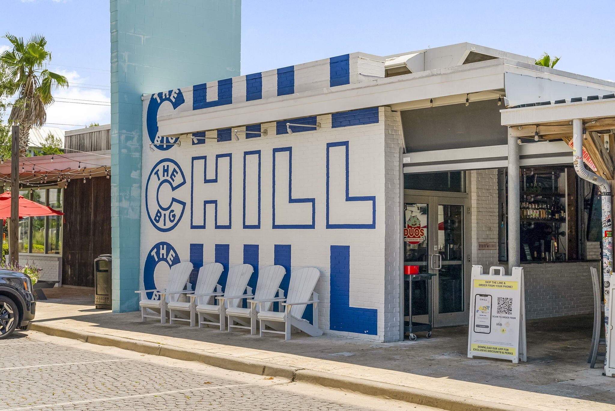 93 Emerald Cove Lane North Inlet Beach, FL 32461 - Photo 65 of 68 a front view of a building with retail shops
