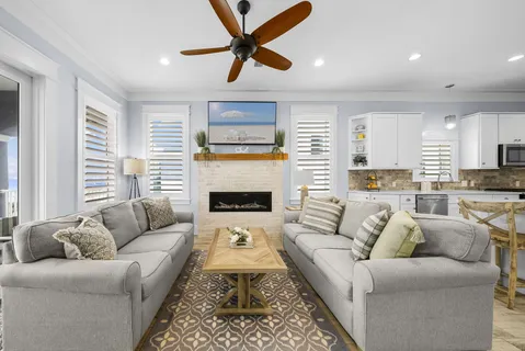 a large white kitchen with stainless steel appliances lots of counter space and wooden floor